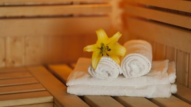 close-up-fresh-towels-yellow-lily-sauna